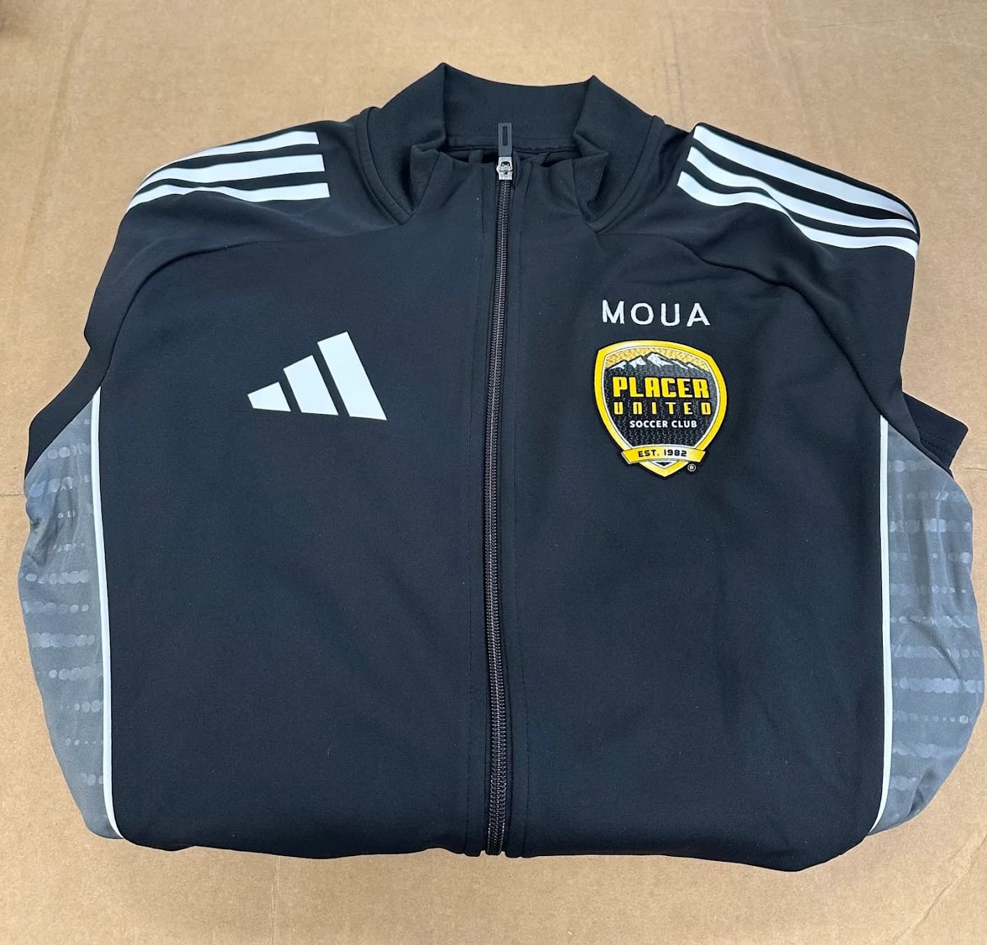 Embroidered team jacket with custom logo, produced by Inca Threads for a Sacramento youth soccer club.