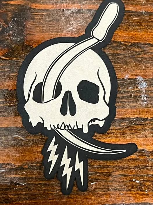 Custom leatherette patch with illustrated design, sewn and ready for apparel by Inca Threads in Sacramento.