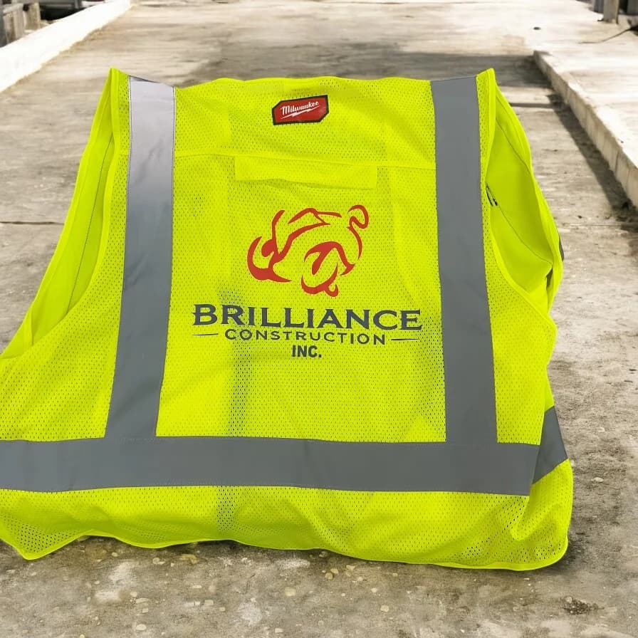 Custom printed high-visibility safety vest with logo, produced by Inca Threads for a Sacramento construction company.