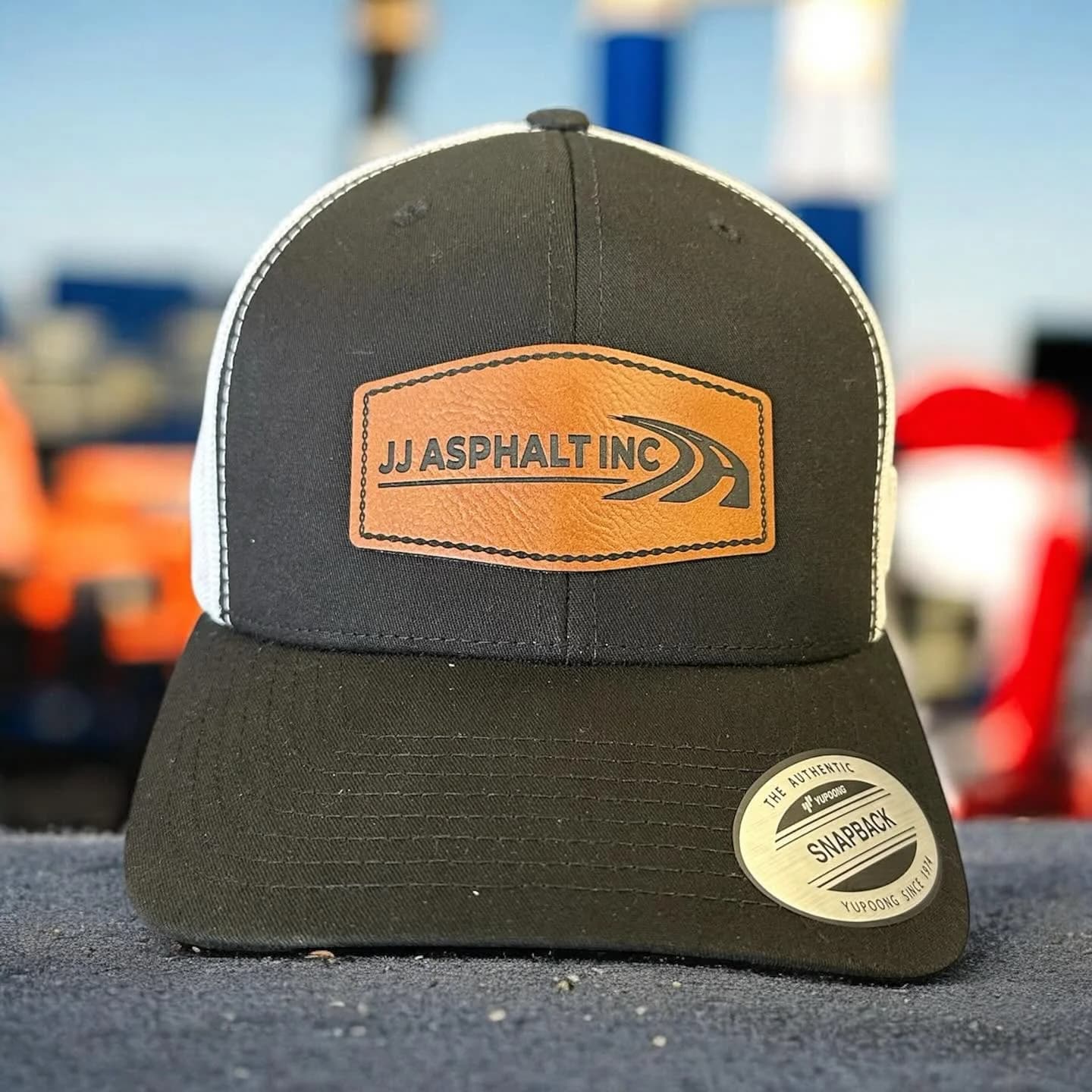 JJ Asphalt leather patch cap with custom logo, crafted by Inca Threads for a Sacramento-area paving company.