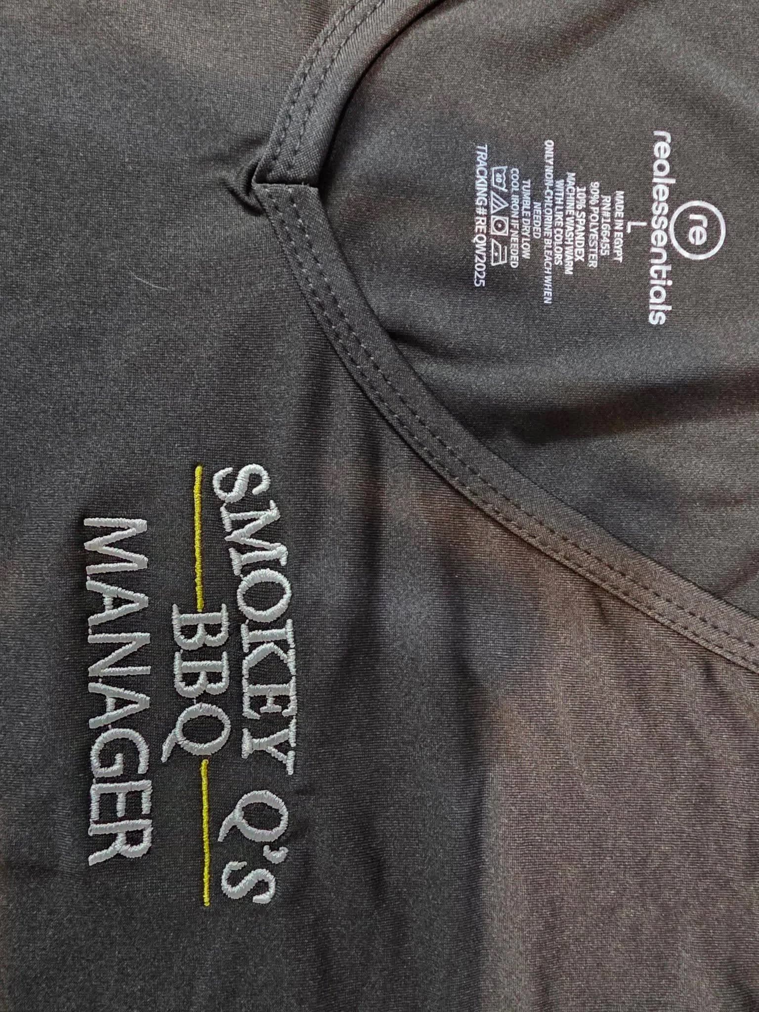 Embroidered staff uniform shirt with custom title stitching, made by Inca Threads for a Sacramento BBQ restaurant.